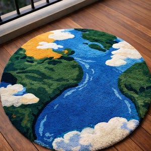 May include: A round rug depicting a colorful Earth design. The rug features a blue ocean, green landmasses, yellow deserts, and white fluffy clouds. The rug is placed on a wooden floor.