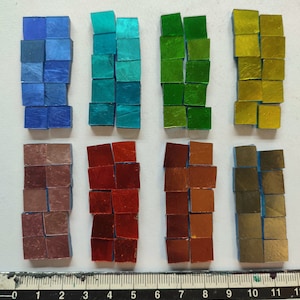 May include: Assortment of 10 small square tiles in various colours, including blue, green, gold, red, brown, and purple. The tiles are arranged in rows of 5, with a ruler below for scale.