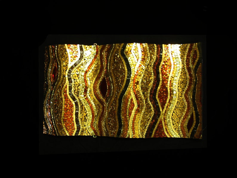May include: A mosaic wall art piece with a wavy pattern in shades of gold, brown, and red.