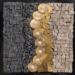 May include: A mosaic art piece with a black and white background and a gold and white design. The design is a series of overlapping circles with a pearl in the center of each circle.