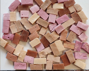 May include: A collection of small, rectangular mosaic tiles in shades of brown, pink, and beige. The tiles are arranged in a random pattern and are ready to be used in a craft project.