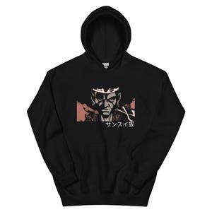 May include: Black hoodie with a graphic print of a character with a crown and the text "サンスイ族" in Japanese.