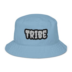 May include: A light blue bucket hat with a white "TRIBE" embroidered on the front.