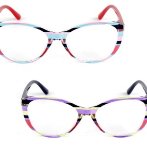 May include: Two pairs of colourful striped cat eye glasses. The first pair has red, pink, blue and black stripes. The second pair has purple, yellow, red and black stripes.