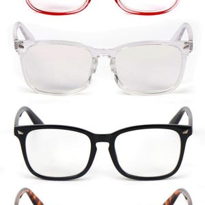 May include: A set of four pairs of rectangular eyeglasses arranged vertically. The frames are translucent pink, clear, solid black, and brown tortoiseshell. Each pair features clear lenses and metallic accents at the outer corners of the frames.