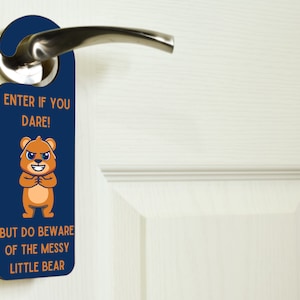 May include: A blue door hanger with a cartoon bear and the text "Enter if you dare! But do beware of the messy little bear."