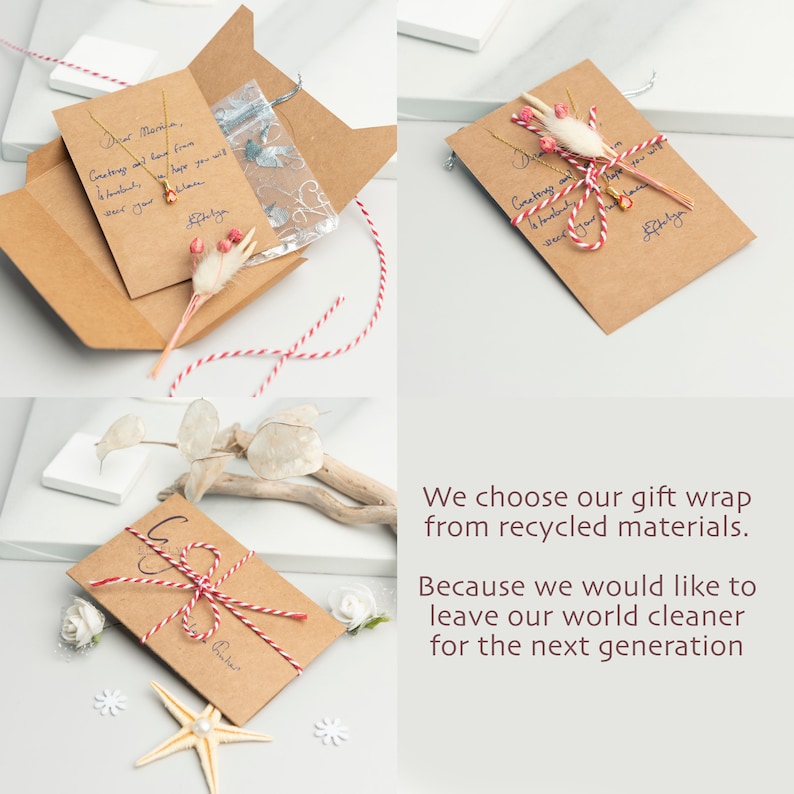 May include: A brown paper envelope with a red and white twine bow. The envelope has a handwritten message that says "Dear Martha. Greetings and love from Honolulu. Hope you will wear your..." The envelope is sitting on a white surface with a white starfish and white flowers.