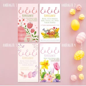 May include: Four Easter-themed spice tags with watercolor illustrations. Each tag features the text "Ei. Ei. Ei. R&uuml;hreigew&uuml;rz" in pink script. Designs include Easter eggs, flowers, and a watering can. The tags are accompanied by meringue cookies and decorated eggs.