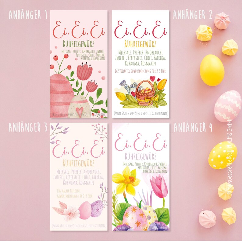 May include: Four Easter-themed spice tags with watercolor illustrations. Each tag features the text "Ei. Ei. Ei. R&uuml;hreigew&uuml;rz" in pink script. Designs include Easter eggs, flowers, and a watering can. The tags are accompanied by meringue cookies and decorated eggs.