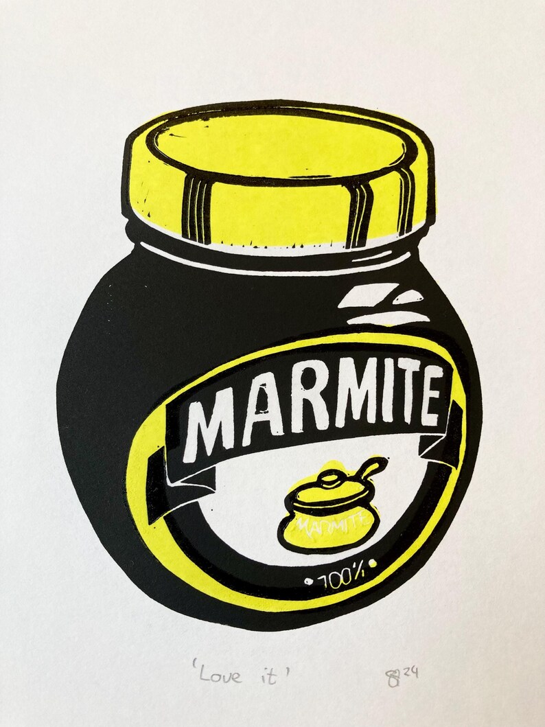 May include: A black and yellow illustration of a Marmite jar with the text "Marmite" and "100%" on the label. The text "Love it" is written below the jar.