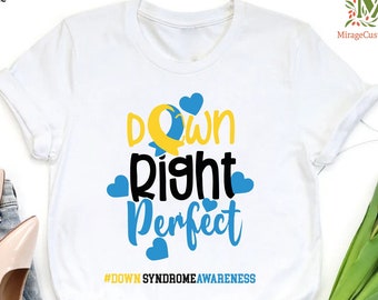 May include: White t-shirt with the text "Down Right Perfect" in black and yellow lettering with blue hearts surrounding the text. The hashtag #DownSyndromeAwareness is printed below the text.