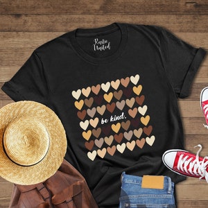 May include: Black t-shirt with a graphic of multicolored hearts and the text "be kind."