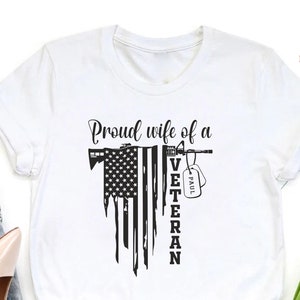 a t - shirt with american flag  and the word  proud wife of a veteran on it