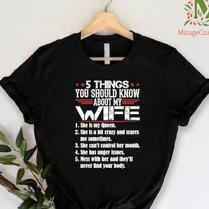 May include: Black t-shirt with white text that reads "5 THINGS YOU SHOULD KNOW ABOUT MY WIFE". The text is followed by a list of five humorous statements about a wife.