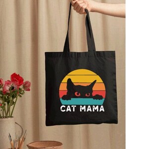 a black bag with a cat mama on it
