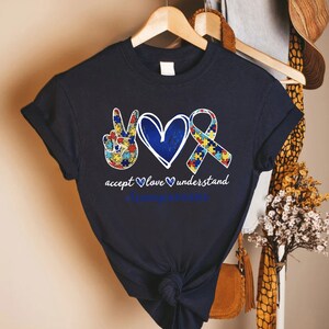 a t - shirt with a heart and two hands on it
