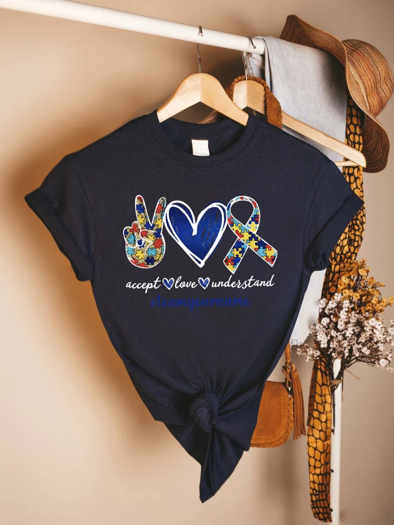 a t - shirt with a heart and two hands on it