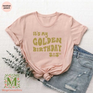 a pink shirt that says it's my golden birthday
