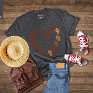 a pair of shoes, a hat, and a t - shirt on a wooden