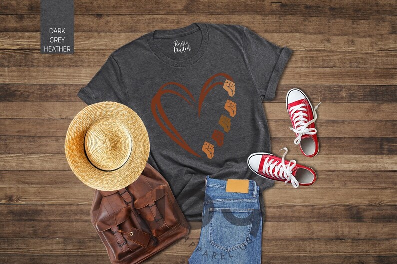 a pair of shoes, a hat, and a t - shirt on a wooden