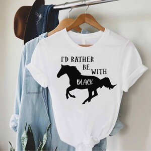 May include: White t-shirt with a black silhouette of a horse and the text "I'd rather be with black".