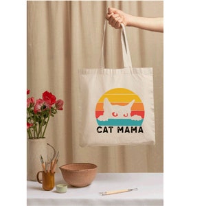 a person holding a bag with a cat on it