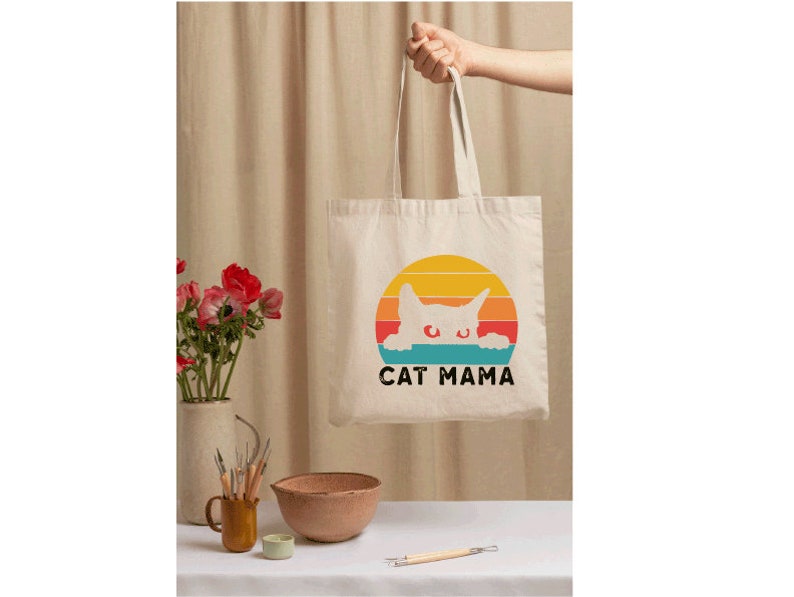 a person holding a bag with a cat on it