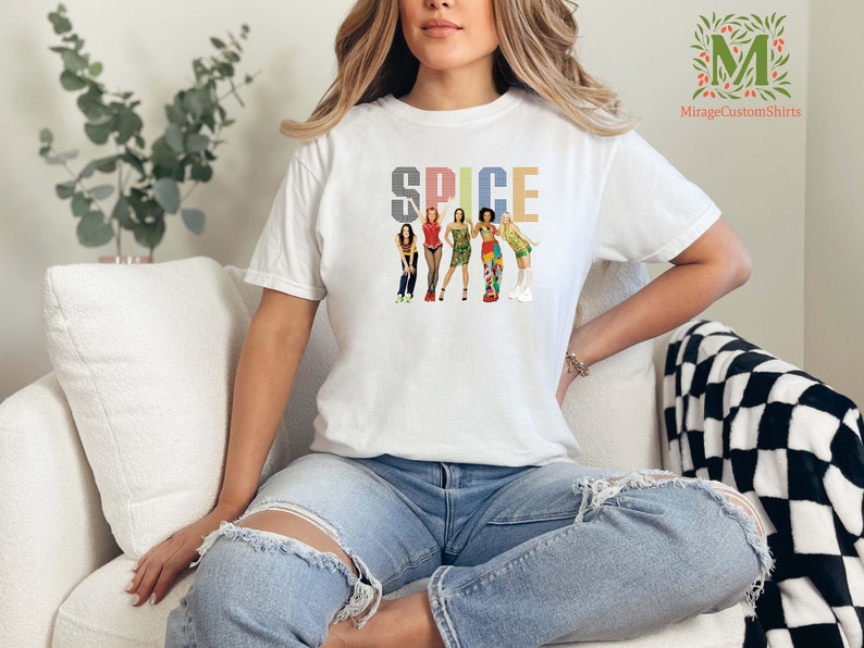 a woman sitting on a couch wearing a t - shirt that says spice