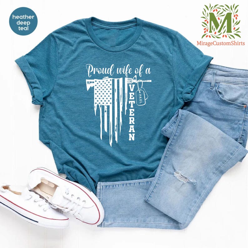 a t - shirt with american flag  and the word  proud wife of a veteran on it