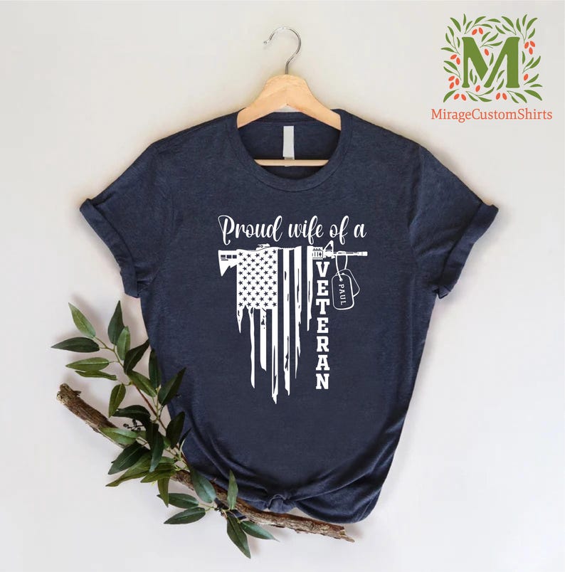 a t - shirt with american flag  and the word  proud wife of a veteran on it