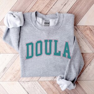 a sweatshirt with the word doula on it