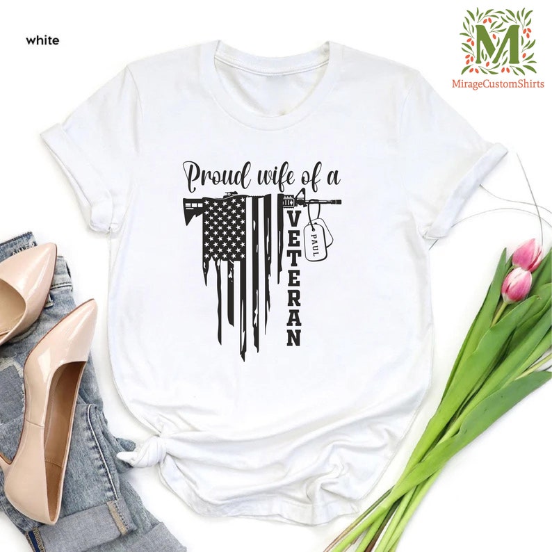 a t - shirt with american flag  and the word  proud wife of a veteran on it