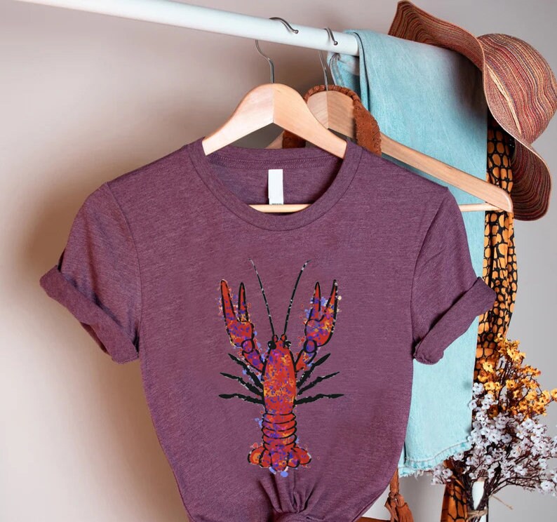 a purple shirt with a lobster on it