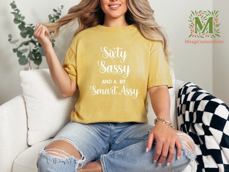 a woman sitting on a couch wearing a yellow shirt