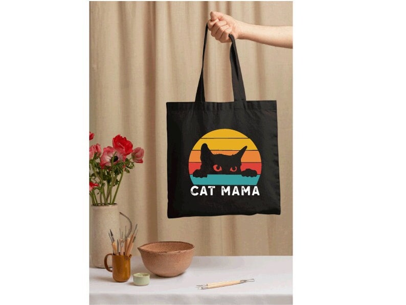 a black bag with a cat mama on it