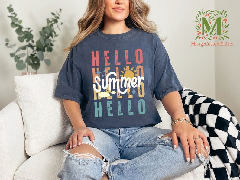 a woman sitting on a couch wearing a t - shirt that says hello summer hello