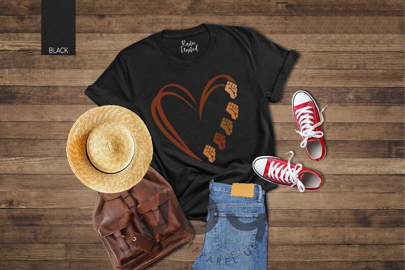a t - shirt with a heart on it next to a pair of jeans and