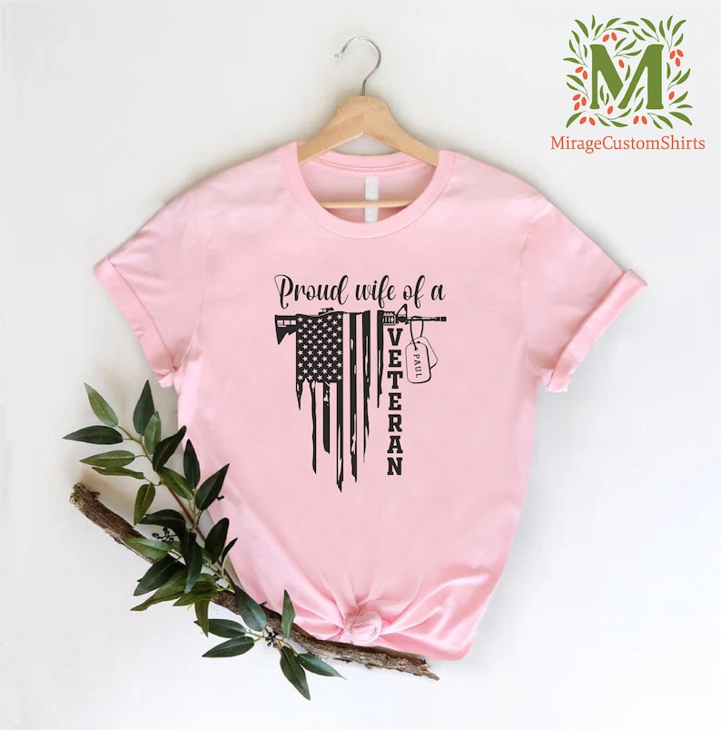 a t - shirt with american flag  and the word  proud wife of a veteran on it