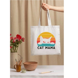 a person holding a bag with a cat on it