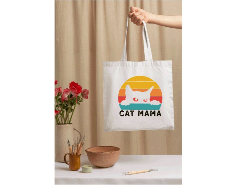 a person holding a bag with a cat on it