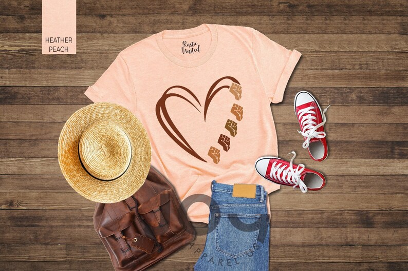 a t - shirt with a heart on it next to a pair of jeans and