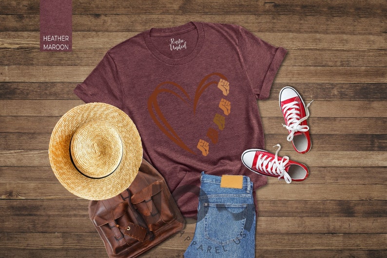 a t - shirt, hat, and pair of jeans on a wooden floor