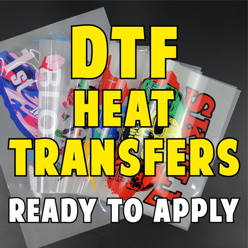 May include: DTF heat transfers ready to apply. The image shows several clear sheets with colorful designs, including a skull, roses, and abstract art. Bold yellow text reads "DTF HEAT TRANSFERS READY TO APPLY."