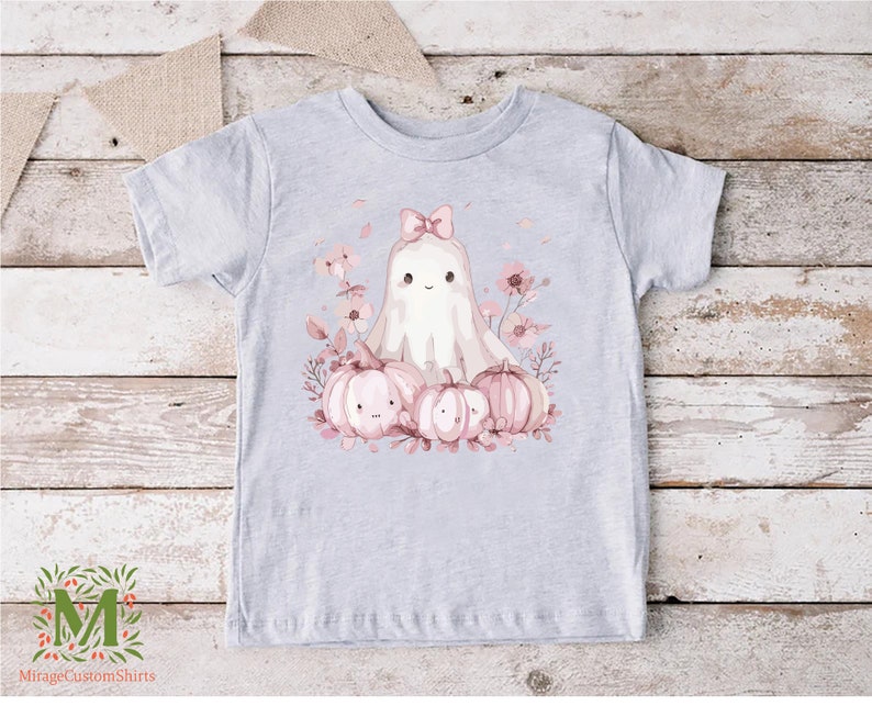 a t - shirt with a picture of a ghost surrounded by pumpkins