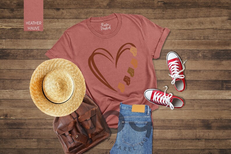 a t - shirt with a heart on it next to a pair of jeans and