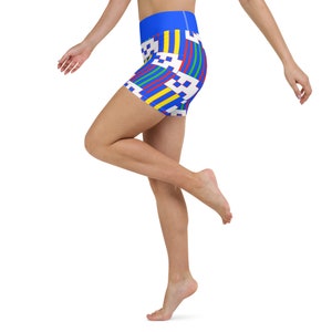 May include: A pair of blue athletic shorts with a colorful geometric pattern. The shorts have a high waist and a fitted silhouette.
