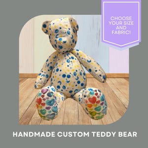 May include: A handmade custom teddy bear with a cream-colored body patterned with blue moons and yellow stars. The bear's feet are decorated with colorful hearts. Text on the image reads: "CHOOSE YOUR SIZE AND FABRIC!"