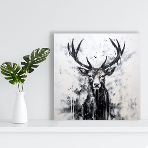 May include: A black and white painting of a deer with large antlers. The deer is facing forward and has a serious expression. The background is a white canvas with black splatters of paint.