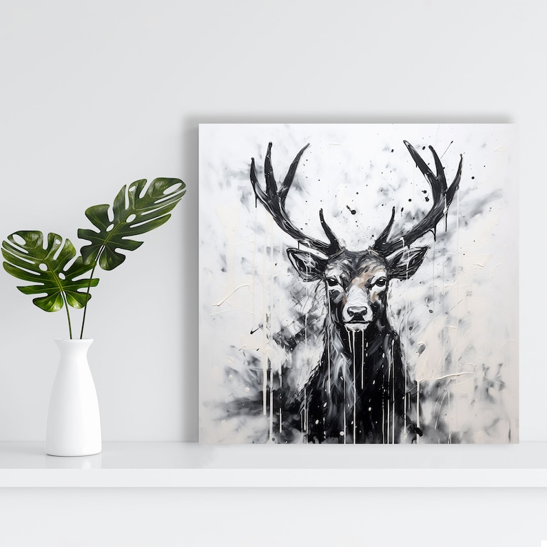 May include: A black and white painting of a deer with large antlers. The deer is facing forward and has a serious expression. The background is a white canvas with black splatters of paint.