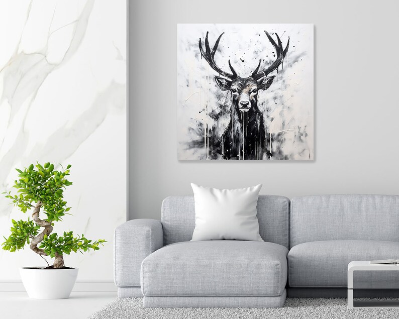 May include: A black and white painting of a deer with large antlers. The deer is facing forward and has a serious expression. The background is a white canvas with black splatters of paint.